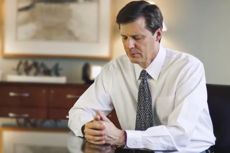 Man Praying in Office
